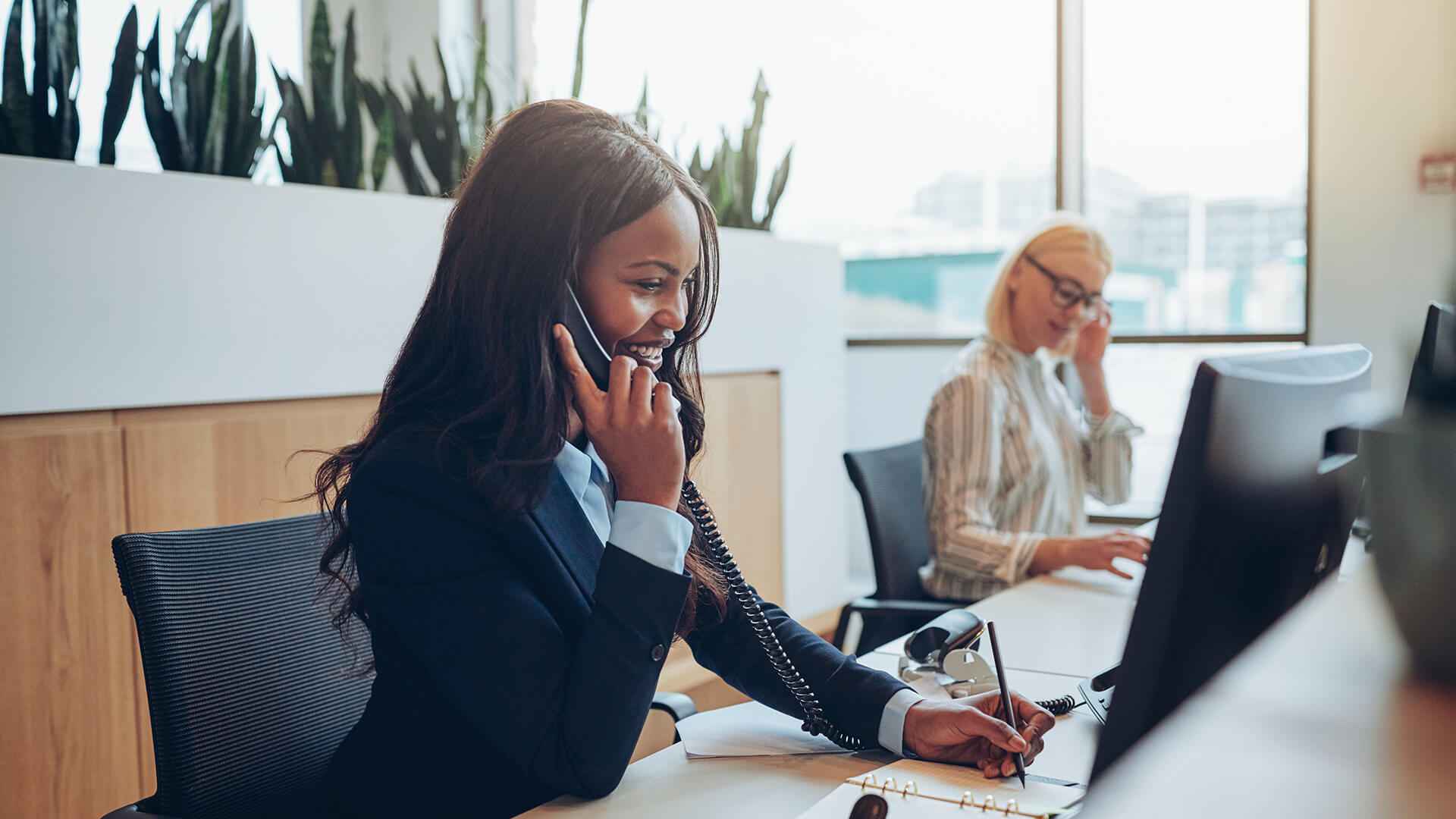 Young African American Businesswoman Smiling And Talking On Phone