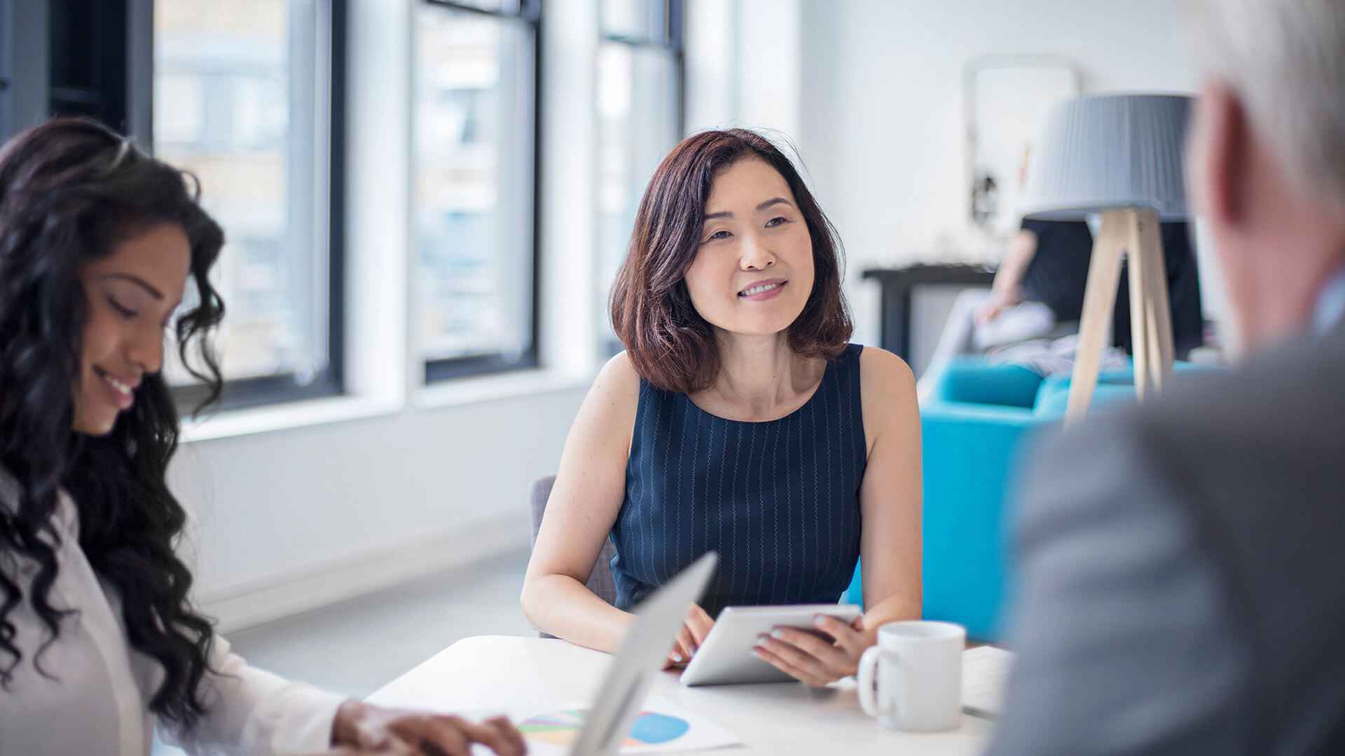 Businesswoman Looking At Male Colleague In Meeting